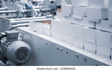 Production of automatic box folder gluer machine for box or carton packaging. Printing industry	 - Shutterstock ID 2230098105