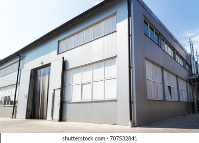 The production building is finished with a white lining with a large entrance. Territory of the plant