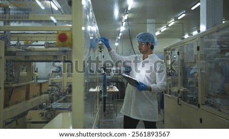 The production control supervisor inspects and controls the operation of machines in the manufacturing line of a canned fish industry