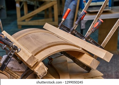 Production Of Curved MDF Cabinet Doors. Metal Clamps Tightening Mdf Details. Wooden Furniture Manufacturing Process