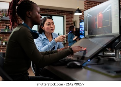 Production department 3D artist team leader with multiple displays on desk working on digital entertainment project. Game developing creative company employee working on videogame level design.