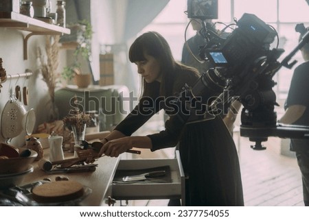 The production designer prepares the scenery on the set. The artist's work in building a frame for filming a movie, advertising, TV series. Modern photography technique.