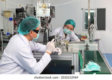 Production engineer with face mask working in factory , Qc engineer checking mask for good quality , Concept of protective action and quarantine to stop spreading of Coronavirus Disease 2019
