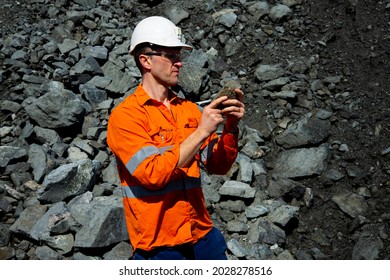 Production Geologist Examining a Rock