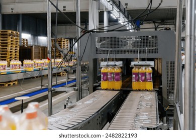 Production line of bottling of beverage into plastic bottles and packing. - Powered by Shutterstock