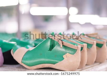 production line conveyor in footwear factory with leather shoe