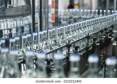 Production line transports empty glass bottles for alcohol - Shutterstock ID 2153212403