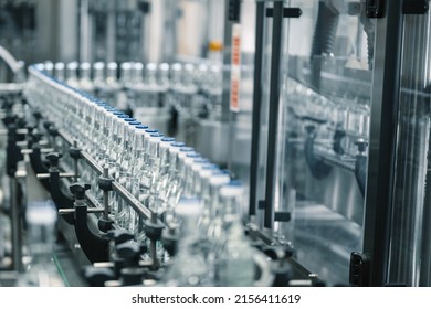 Production line transports empty glass bottles for alcohol - Shutterstock ID 2156411619