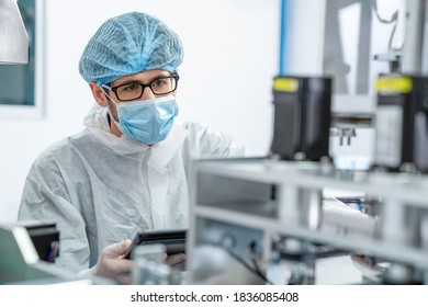 Production line worker with face mask working in electronic factory . Concept of protective action and quarantine to stop spreading of Coronavirus Disease 2019 or COVID-19 . - Shutterstock ID 1836085408