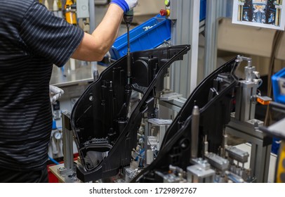 Production Operator Assembling Frontlight Headlamp, Headlight For A Vehicle Or A Car In Automotive Industry