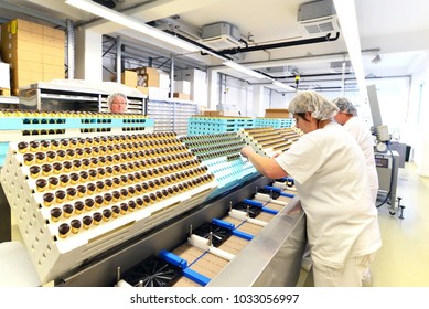 Production Of Pralines In A Factory For The Food Industry - Women Working On The Assembly Line 