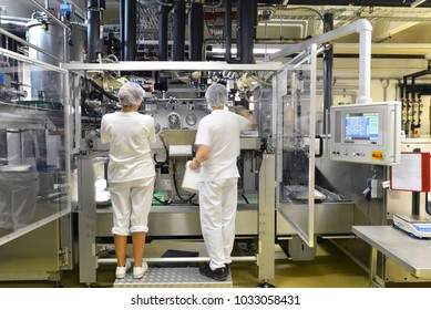 Production Of Pralines In A Factory For The Food Industry - Conveyor Belt Worker With Chocolate 