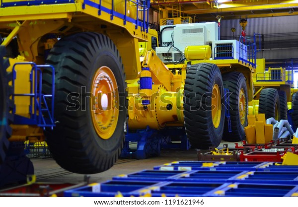 Production process of heavy mining trucks at the\
factory. Dump truck on the Industrial conveyor in the workshop of\
an automobile plant. Manufacturer of haulage and earthmoving\
equipment, haul\
trucks