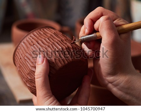 production process of pottery. applying a texture on the pottery.