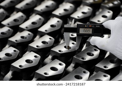 production quality control,Engineer's hand measuring metal parts with digital vernier caliper on white background.quality control of machined parts on lathe

