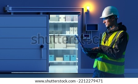 Production refrigerator chamber. Man engineer. Refrigerator storage. Door to cold store opens. Warehouse for storage at low temperatures. Guy with laptop adjusts refrigerator. Man engineer in freezer