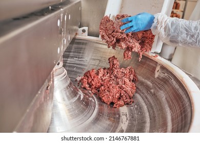 production of sausages from veal, chicken and pork meat, the worker holds sausages in his hands and packs
 - Powered by Shutterstock