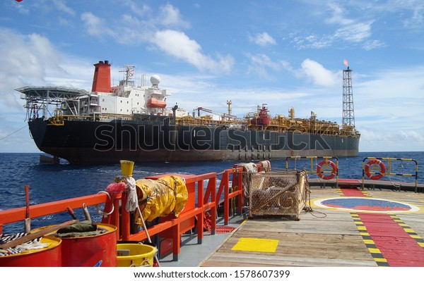 A floating production storage and\
offloading (FPSO) unit at work off the shore of\
Thailand\
