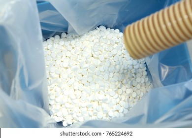 Production Of Tablets. Tablets Poured Into Sterile Packaging. Many Pills. Manufacturing White, Round Tablets For Health.