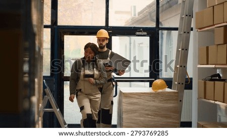Production technicians perform warehouse inventory controls, keeping quality standards high. Efficient experts in storage workspace prepare to ship parcels, crosschecking delivery info.