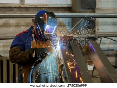 Production. A welder at work in the workshop
