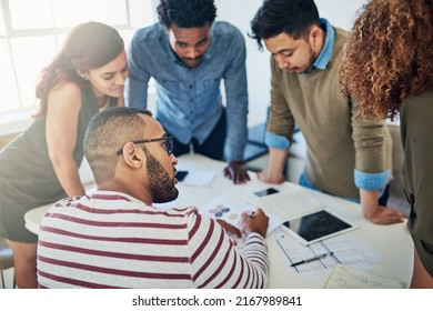 Productivity Is A Team Effort. Shot Of A Group Of Colleagues Having A Meeting In A Modern Office.