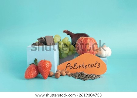 Products containing a lot of polyphenols in their composition. Grapes, onions, garlic, chocolate, tea, nuts, apple, strawberries, close-up on a light background and the inscription 