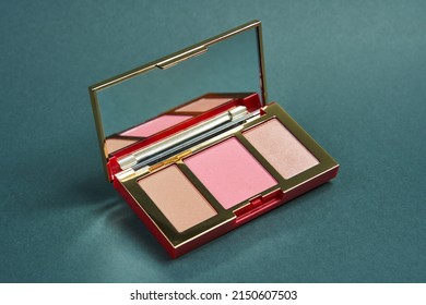 Products For Contouring Face. Palette With Blush Bronzer And Highlighter On A Gray Background