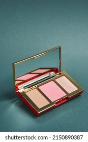 Products For Contouring Face. Palette With Blush Bronzer And Highlighter On A Grey Background