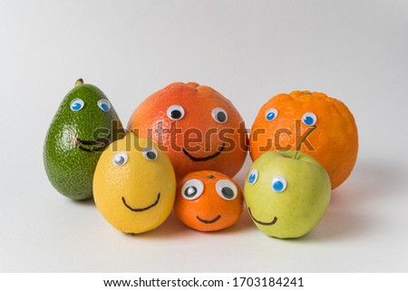 products with funny faces Googly eyes and painted smiles. Different nationalities concept.