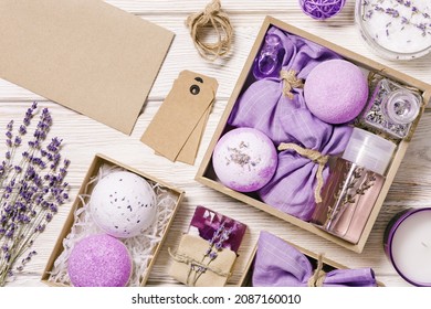 Products With Lavender Essential Oil As Handmade Gift Box, Bath Bombs, Lavender Spray And Sachets On Wooden Table. Mindful Gifting, Natural Aromatherapy Cosmetics For Body Care, Flat Lay