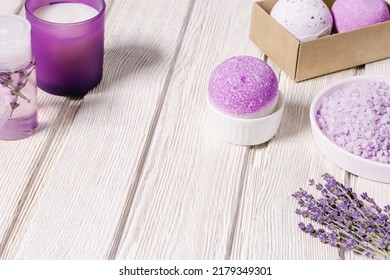 Products With Lavender Essential Oil For Relaxation And Stress Relief. Aromatherapy Sleep Spray, Sea Salt, Bath Bombs, Fragrant Candle. Natural Lavender Cosmetics For Spa And Body Care, Wooden Table