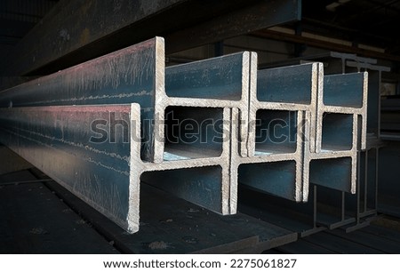 Products of the metal structure factory, I-beam steel, H-beam welding, Selective Focus, raw materials used in building construction. Steel floor beams in piles. Construction steel, Wi-Frank steel.