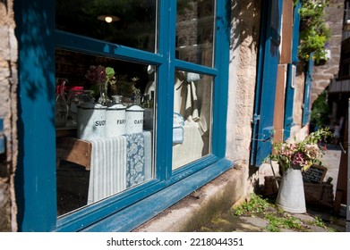 Products For Sale Displayed In The Blue Tinted Window