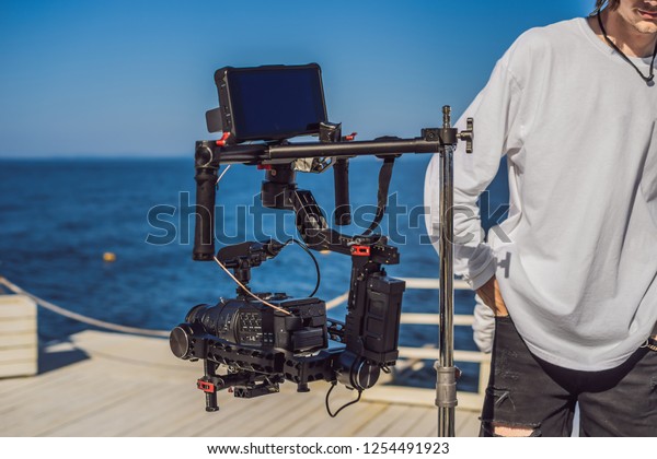 profeccional cinema camera on a 3-axis\
camera stabilizer system on a commercial production\
set