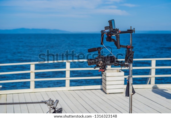 profeccional cinema camera on a 3-axis\
camera stabilizer system on a commercial production\
set