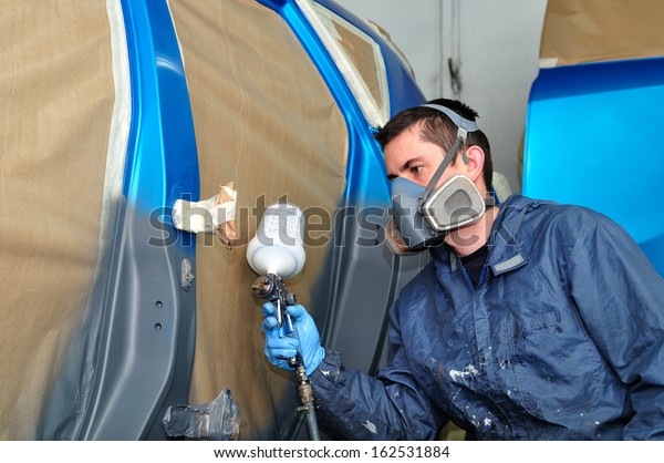 Profesional car painting\
in a paint booth.