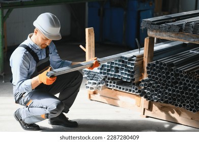 Profesional fabric worker. Metal processing plant. A worker at a metal profile warehouse - Powered by Shutterstock