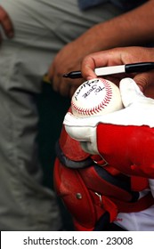 Professianl Ball Player Signs An Autograph
