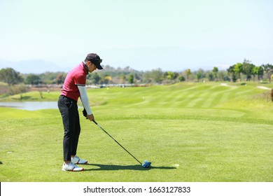 Professinal Golf Player On Golf Course. Pro Golfer Taking A Shot 