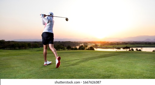 Professinal Golf Player On Golf Course. Pro Golfer Taking A Shot At The Sunset