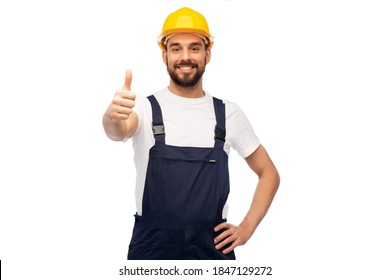 profession, construction and building - happy smiling male worker or builder in yellow helmet and overall showing thumbs up over white background - Powered by Shutterstock