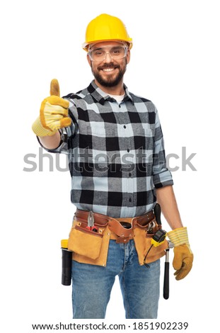 profession, construction and building - happy smiling male worker or builder in helmet and goggles showing thumbs up over white background