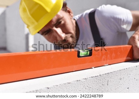 profession construction worker - work on a building site construction of a residential house - quality control
