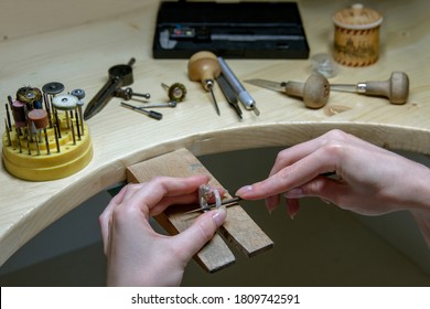 Profession jeweler. Craft jewelry making. Hands of an jeweller . Handwork . Close up.