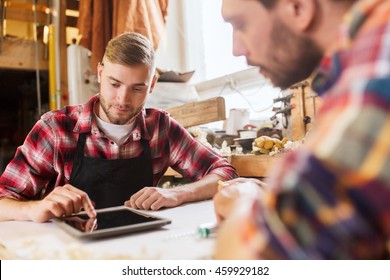 profession, technology and people concept - two workmen with tablet pc computer and blueprint at workshop - Powered by Shutterstock