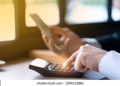 Professional accounting estimate finance unrecognized number from financial report. Accountant using calculator to calculate variable saving cost, return company benefit, money, profit and investment