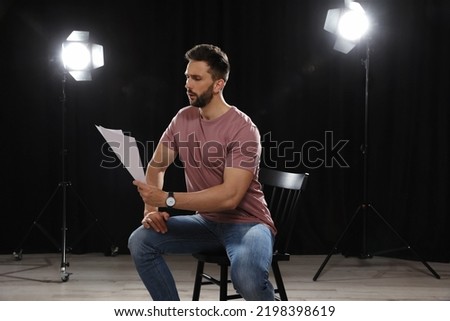 Professional actor reading his script during rehearsal in theatre
