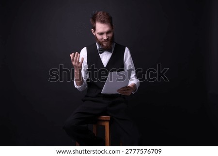 Professional actor with script performing on black background