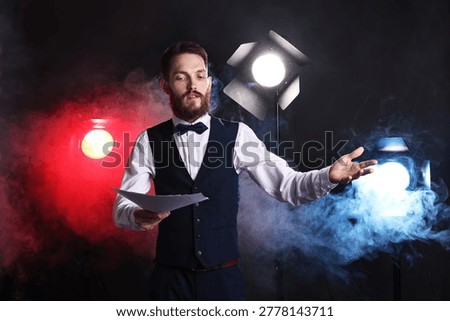 Professional actor in suit with script performing on stage